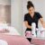 Salon owner organizing LYCON professional waxing products and equipment in a clean beauty treatment room